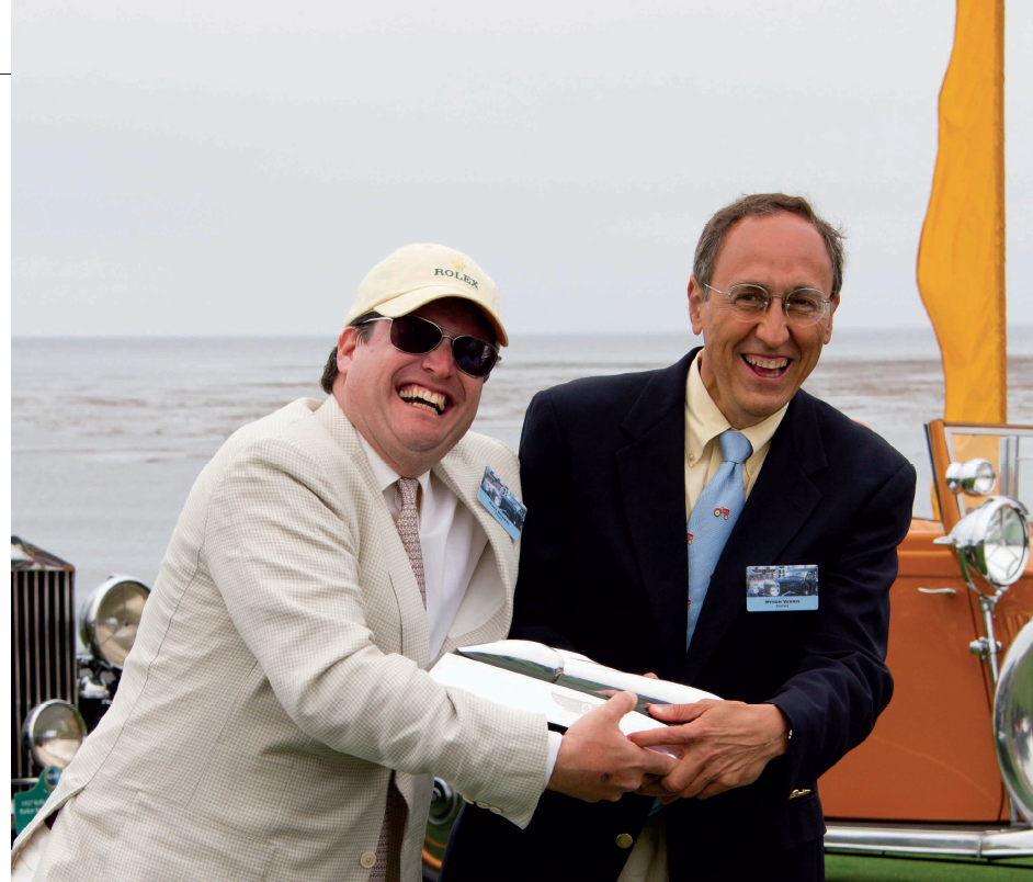 Authors of A Quiet Greatness Mark R. Brinker and Myron T. Vernis fight over a trophy at the Pebble Beach Concours d'Elegance.